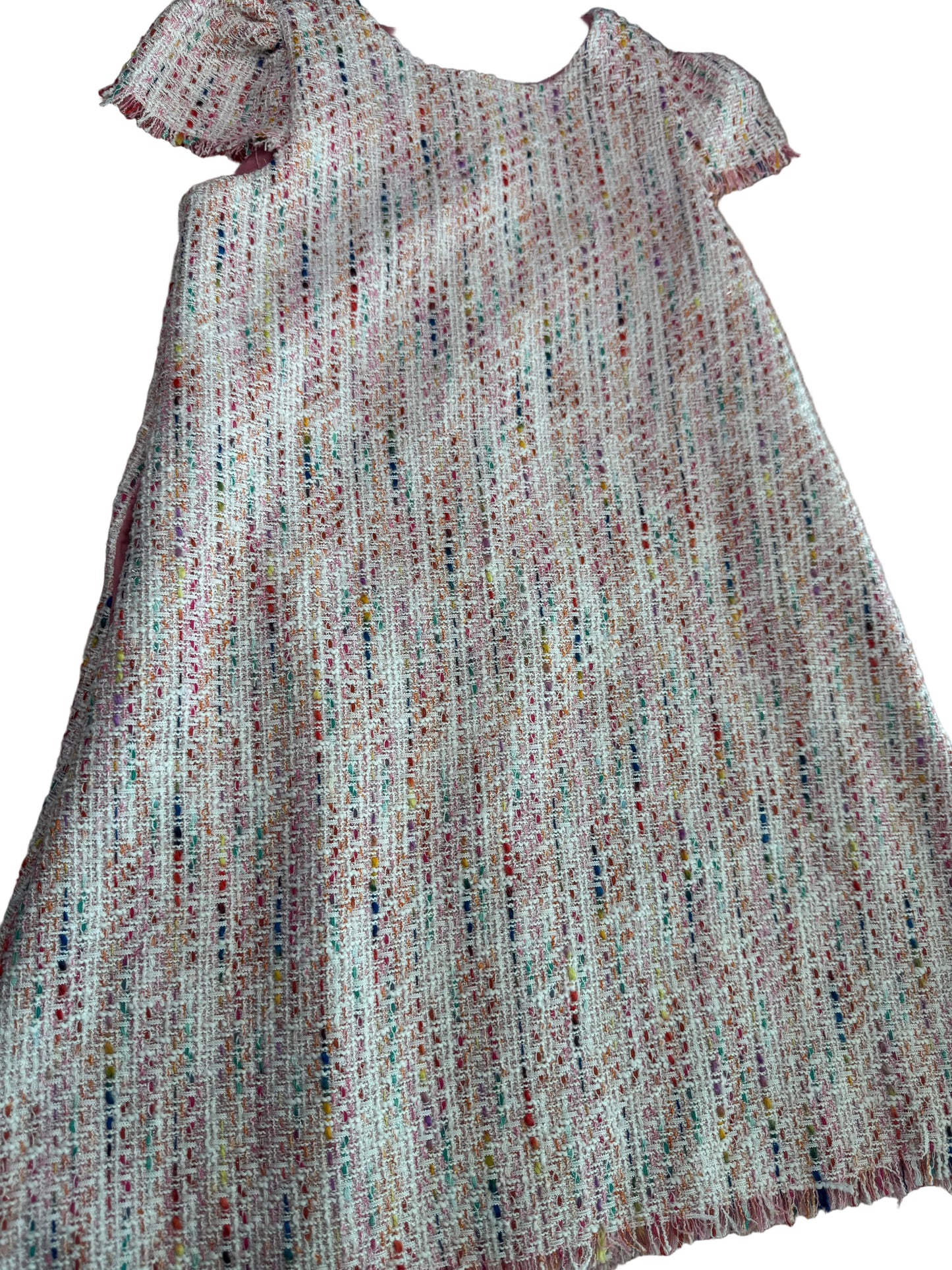 Close-up of textured fabric with a multicolor pattern on a neutral background