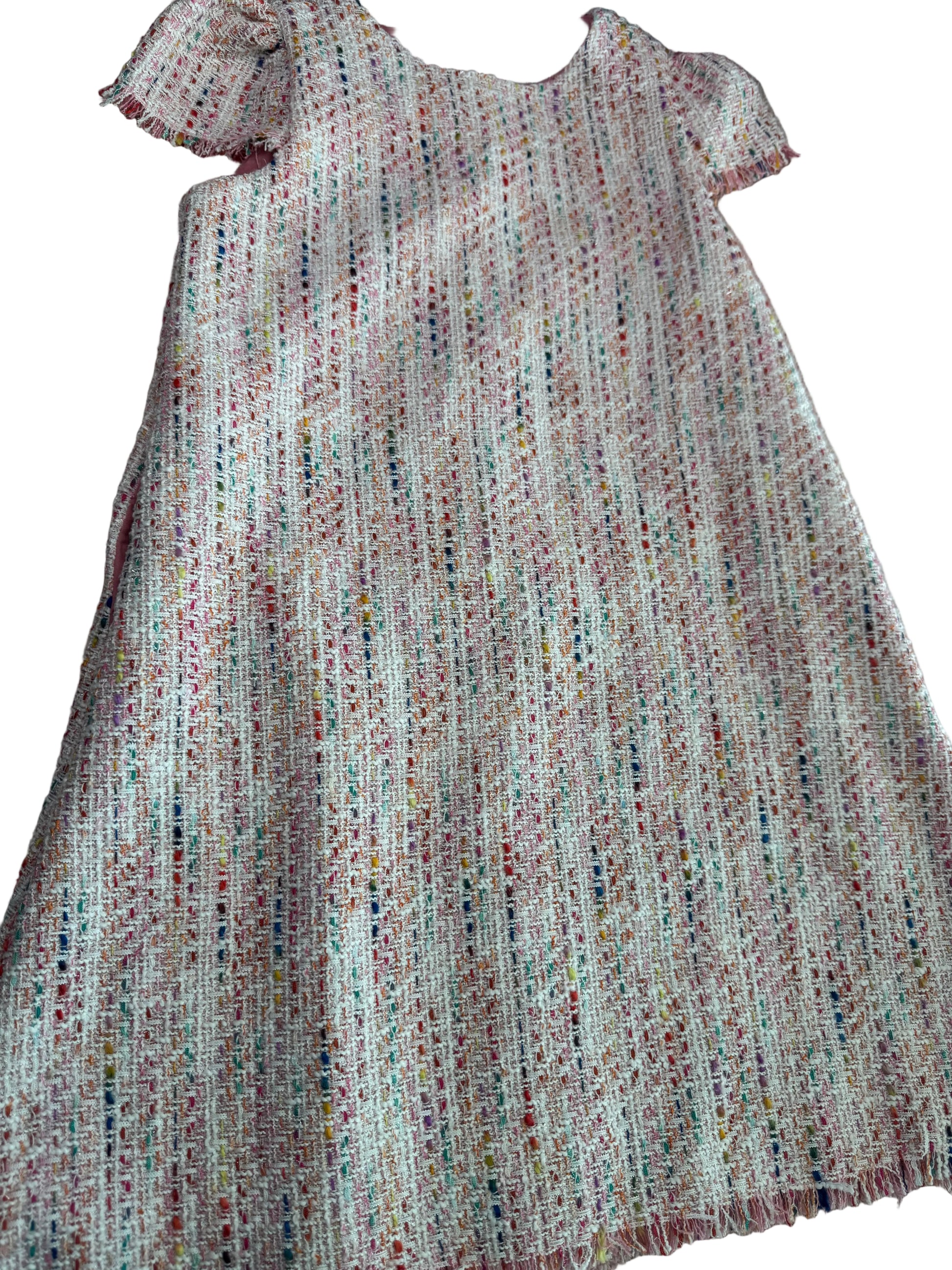 Close-up of textured fabric with a multicolor pattern on a neutral background