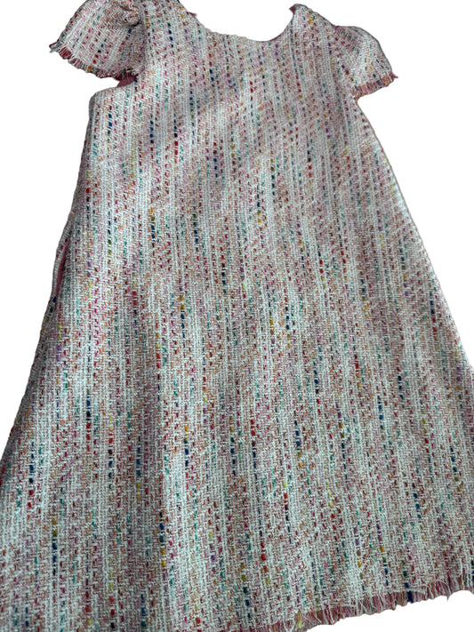 Close-up of textured fabric with a multicolor pattern on a neutral background